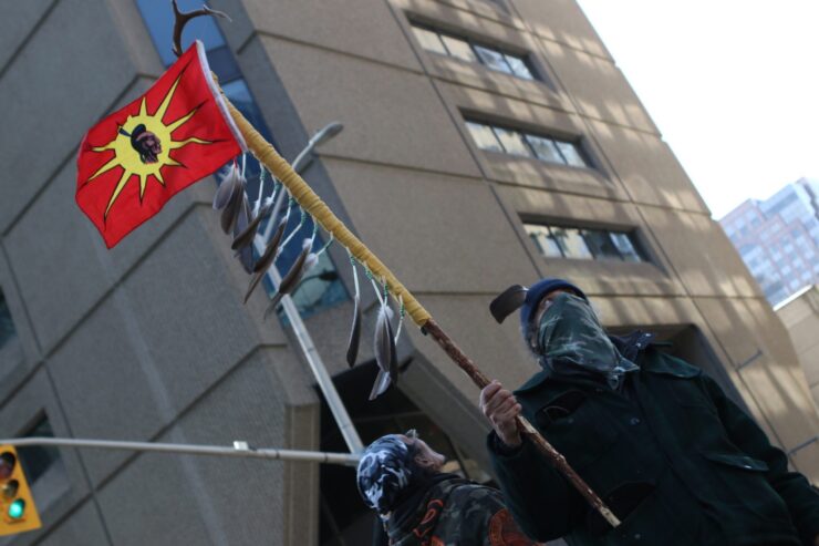 A man stands on the street at the rally of solidarity with the Wet'suwet'ens in Febuary. Photo: Aaron Hemens/Fulcrum