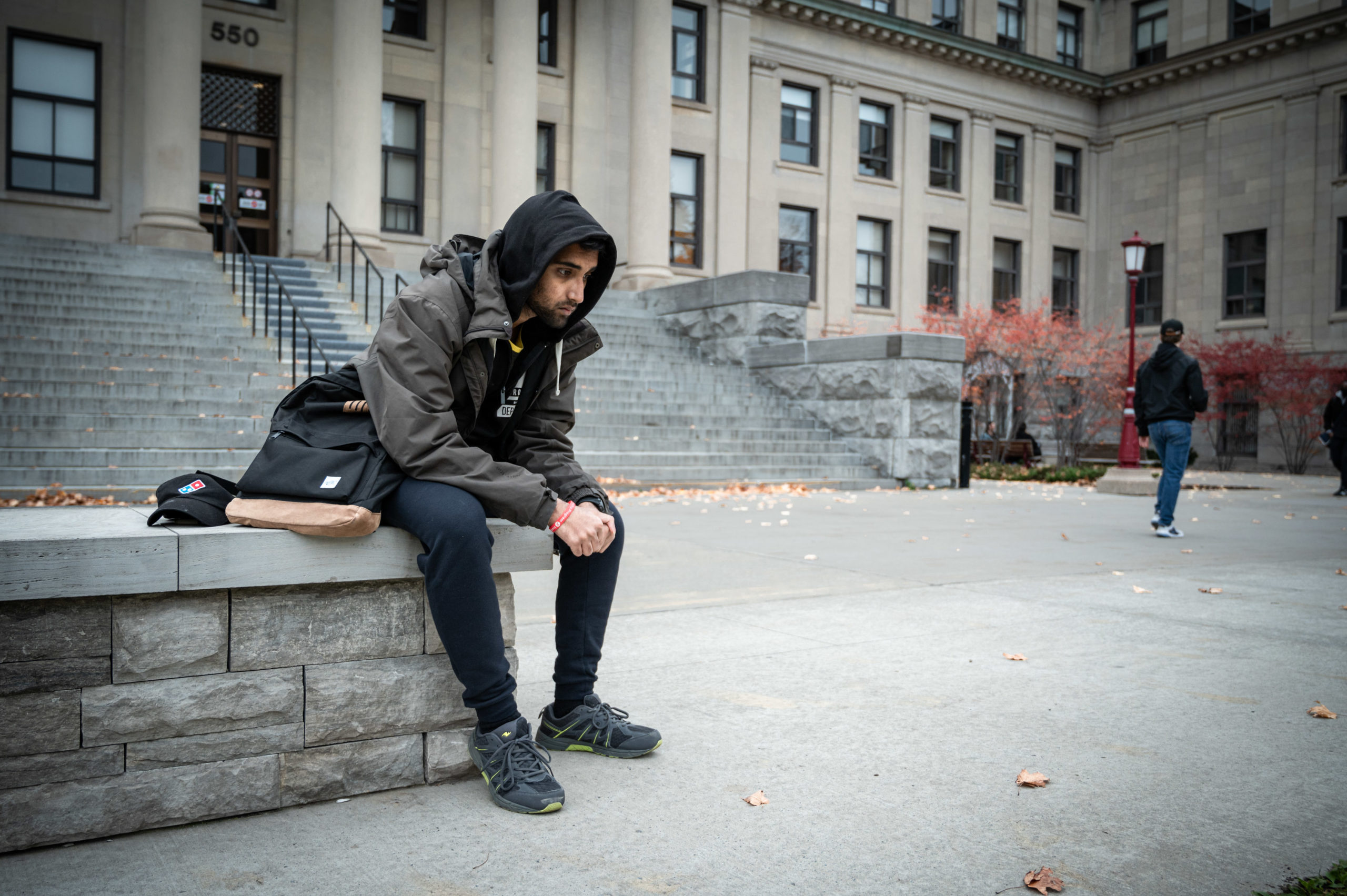 Image of a student looking sad on campus