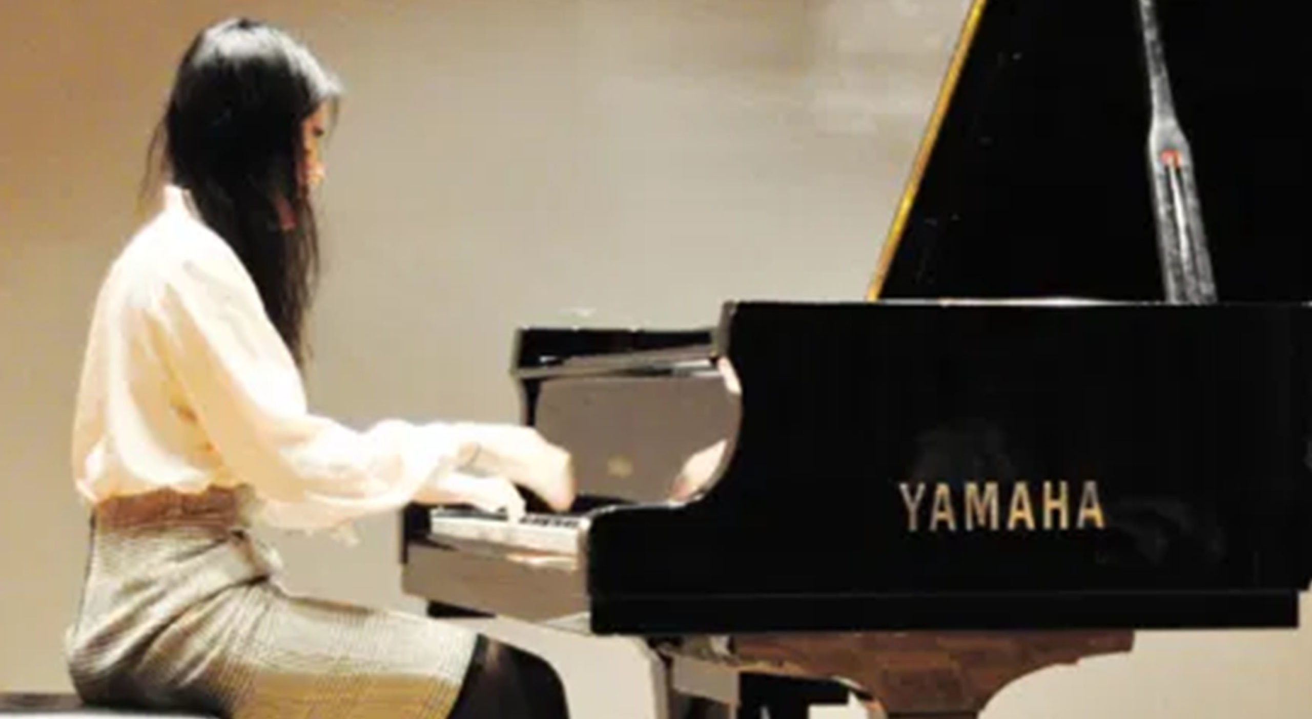 U of O student playing the piano