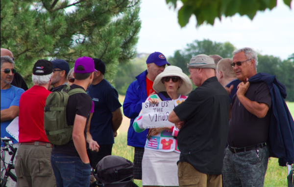 Old lady with anti-vaxx sign