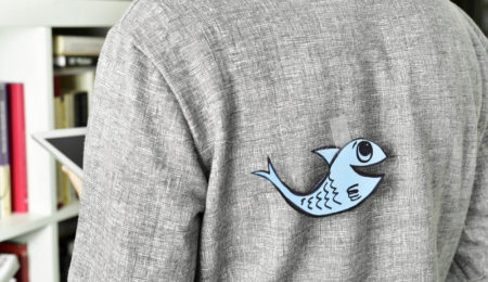 paper fish on someone's back