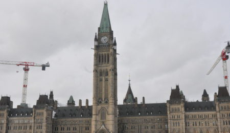 Canadian parliament with cranes.