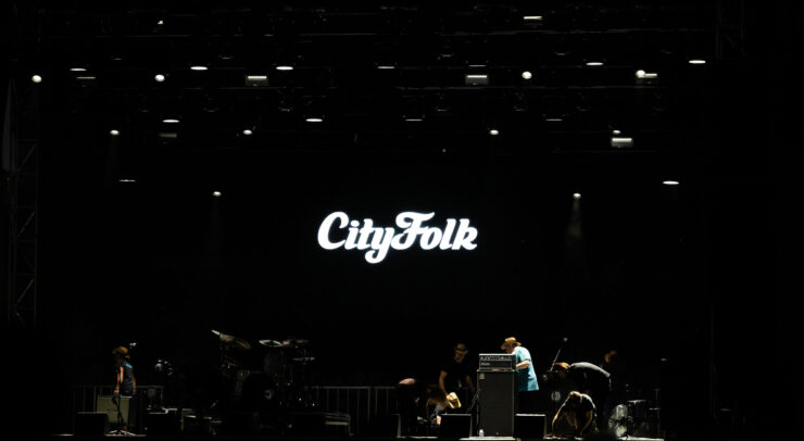 City Folk logo on a dark stage