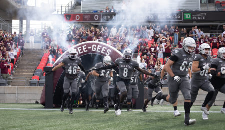 Gee-Gees coming onto the field.