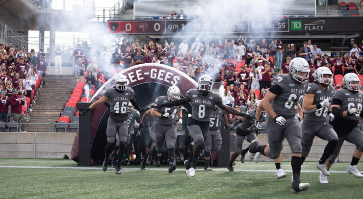Gee-Gees coming onto the field.