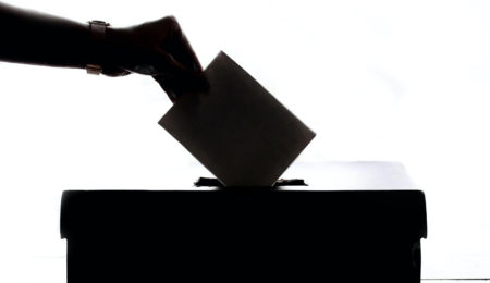 Hand putting vote into box