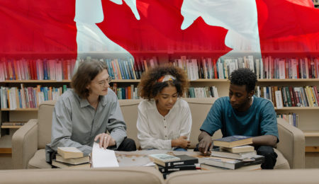 Students with the Canadian flag in the background