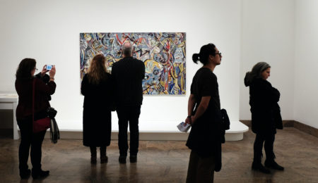 Photo of people looking at an artwork in a museum