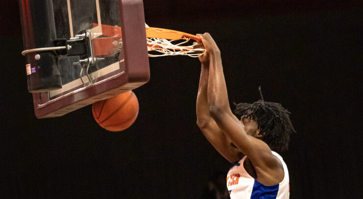 Athlete dunking basketball