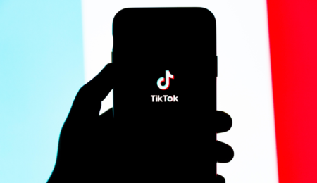 Photo of cellphone with TikTok logo on the screen