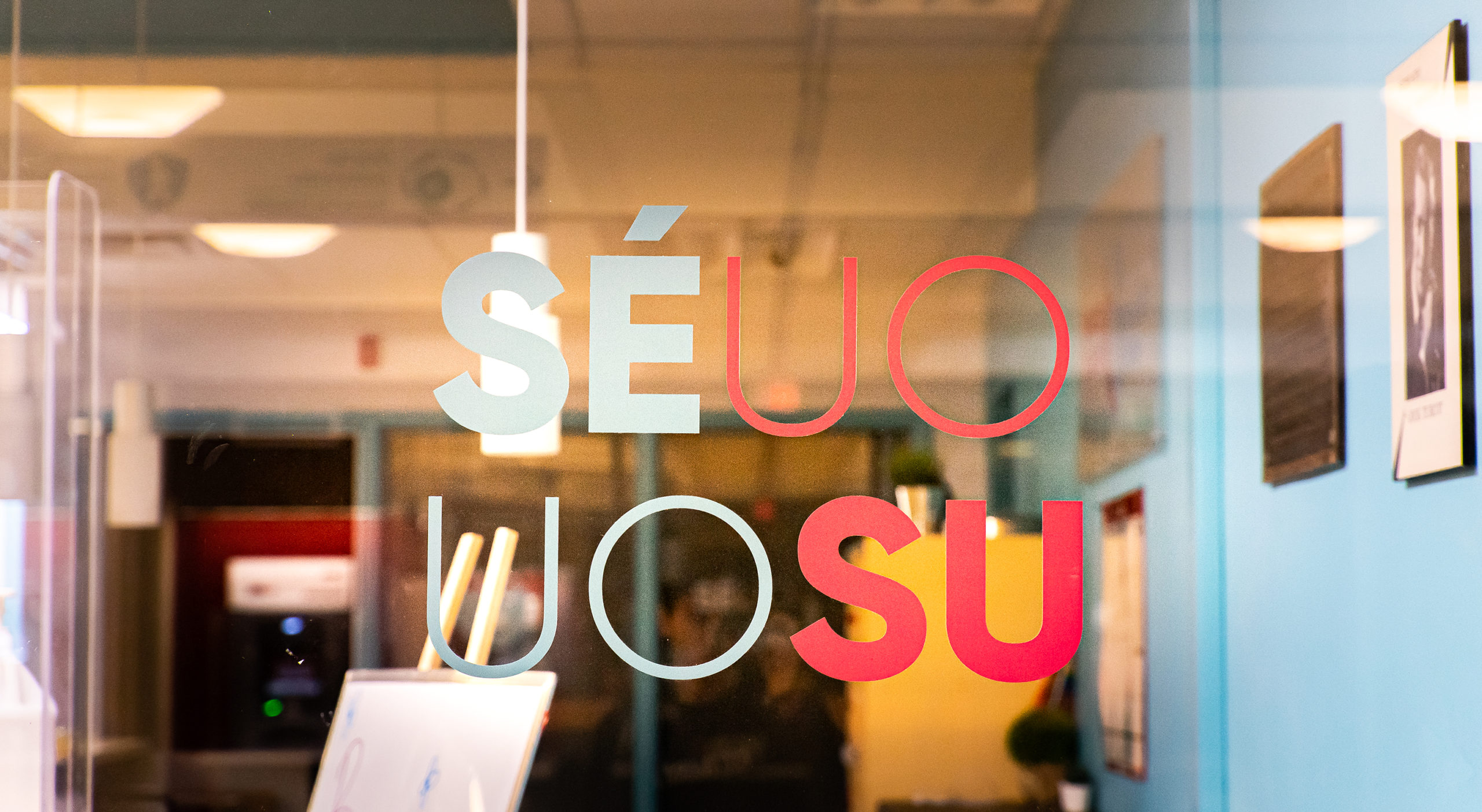 UOSU logo on a clear office window