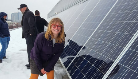 Erin Tonita next to solar panel Erin