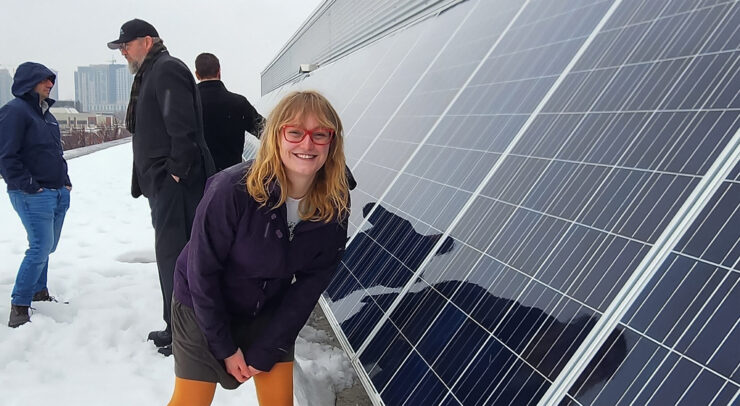 Erin Tonita next to solar panel Erin