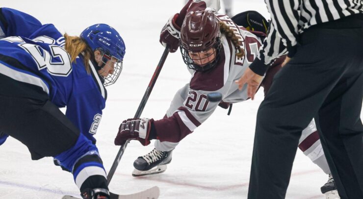 women's hockey player lines up for a faceoff