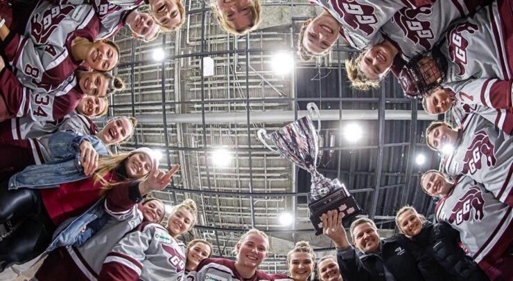 team celebrates around Alert Cup after the game