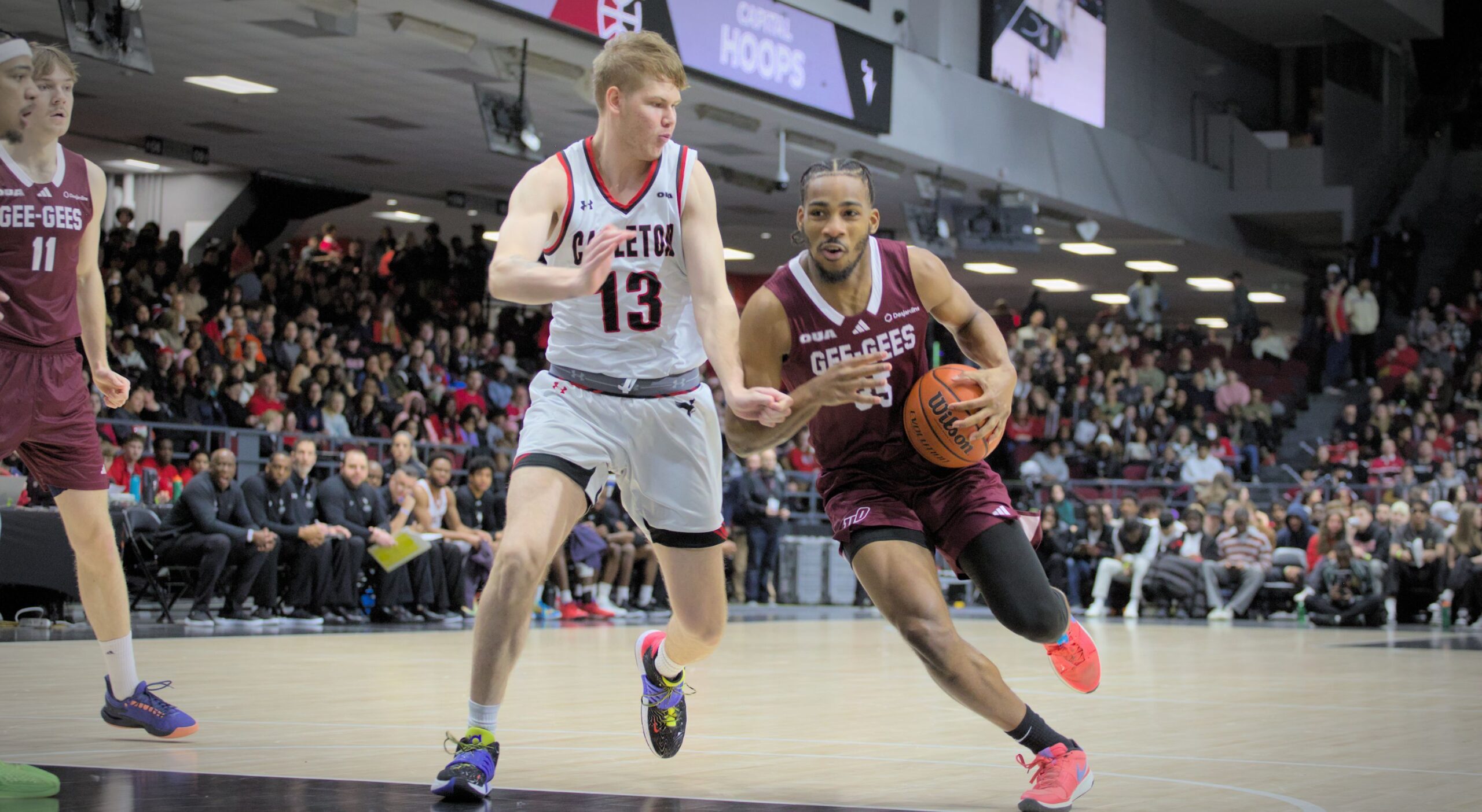 a basketball player runs around an opposing player