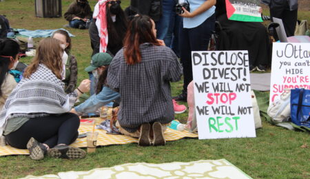 sign saying: disclose, divest, we will not stop, we will not rest