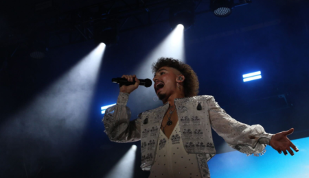 A close-up shot of Greta Van Fleet on TD Stage with blue light.