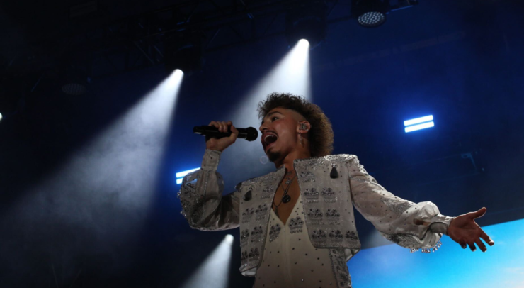 A close-up shot of Greta Van Fleet on TD Stage with blue light.