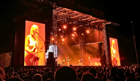 A close up shot of the CityFolk TD Stage cast in orange light.