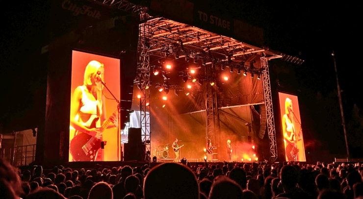 A close up shot of the CityFolk TD Stage cast in orange light.