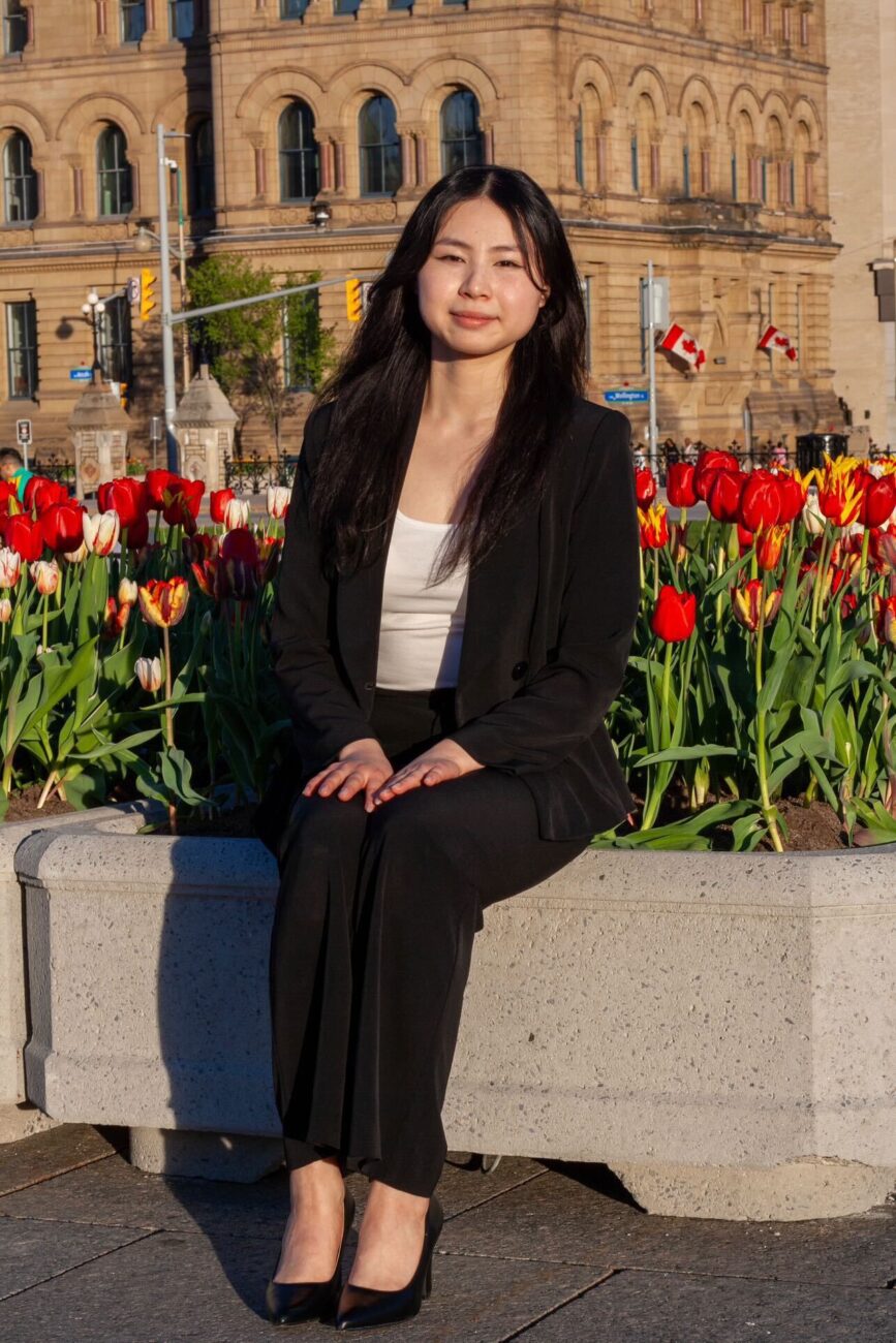 jasmine jin sits in front of tulips