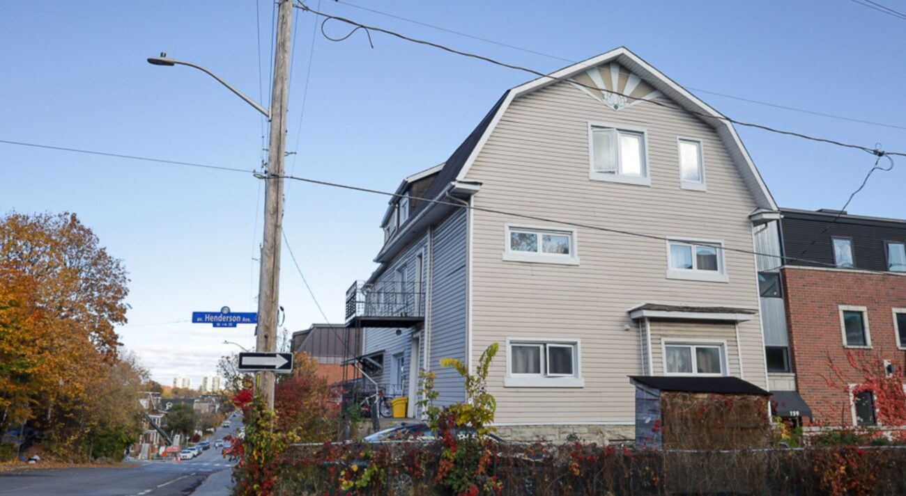 The iconic lotus logo overlooks the corner of Henderson Ave. and Somerset St. E.