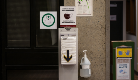 a mask dispenser sits on the U of O's campus