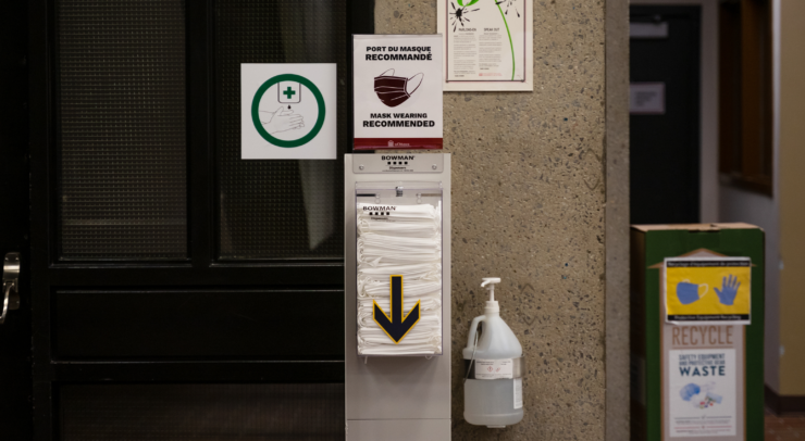 a mask dispenser sits on the U of O's campus