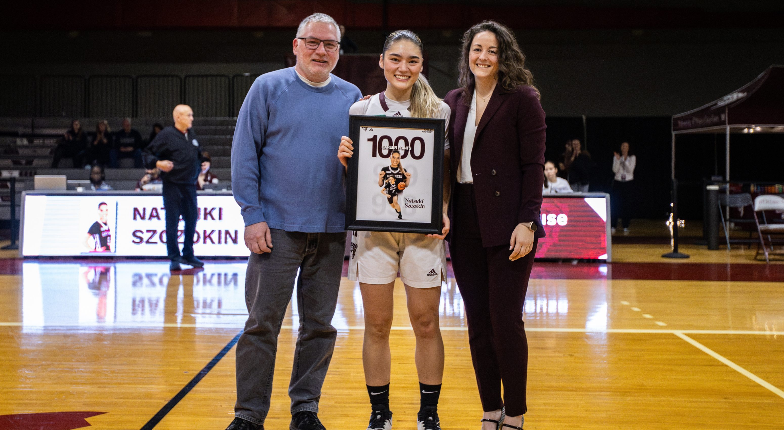 natsuki szczokin is presented with framed picture from her dad and coach