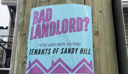A poster on a telephone pole reads: "Bad landlord? You are not alone: Tenants of Sandy Hill"