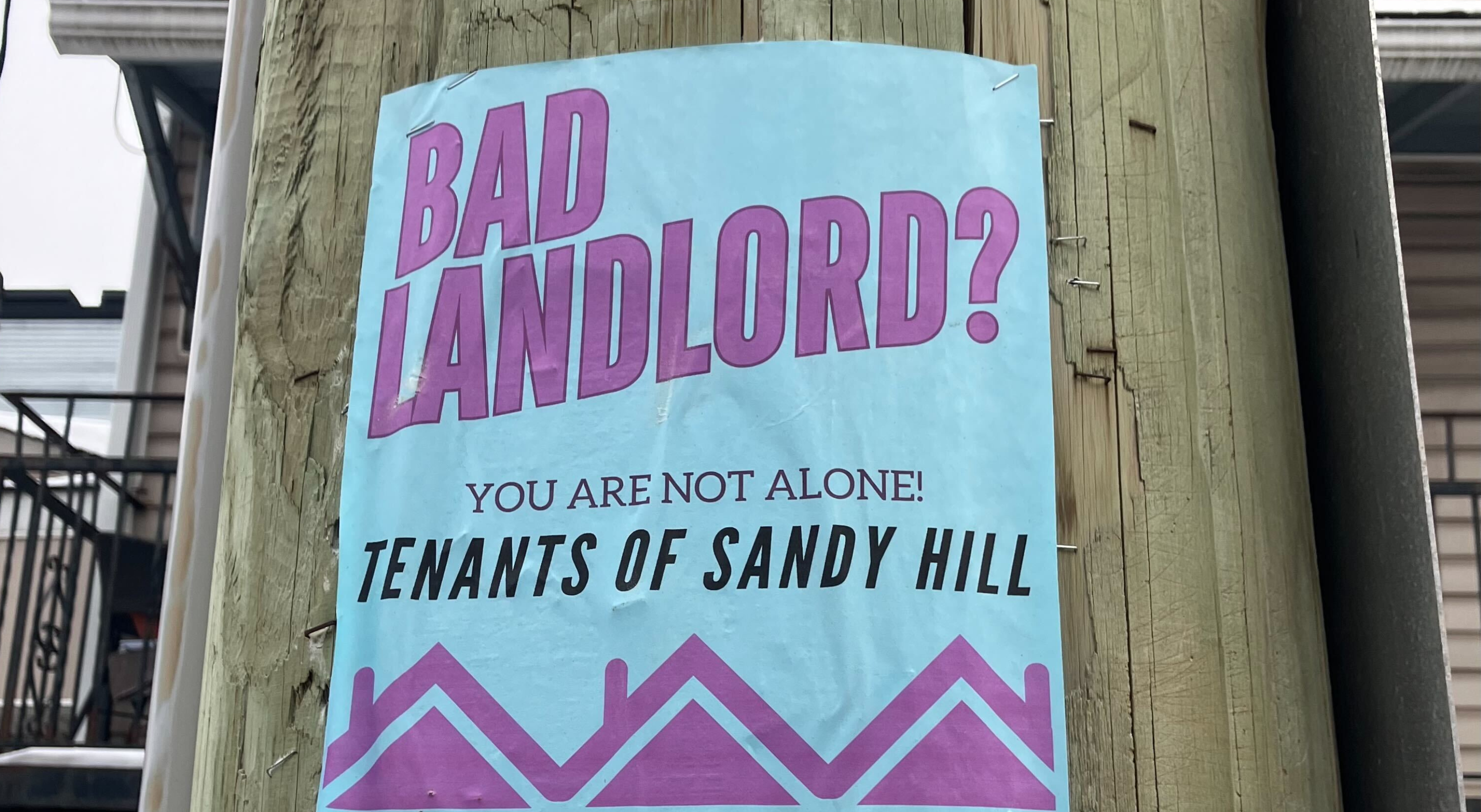 A poster on a telephone pole reads: "Bad landlord? You are not alone: Tenants of Sandy Hill"