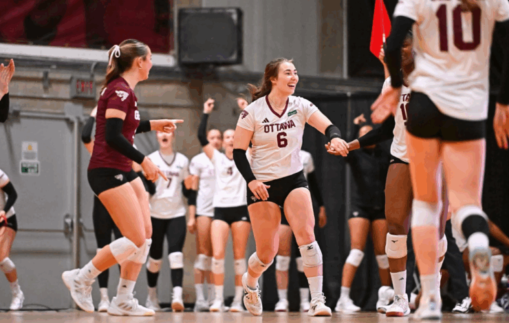 Brynn Lewis high-fives a teammate after winning a point