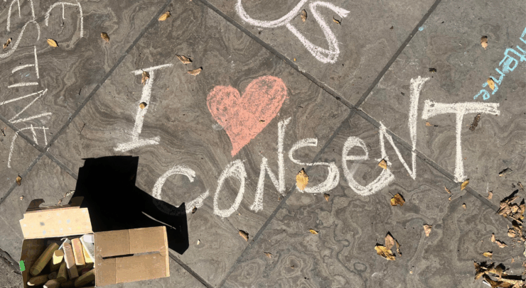 Chalk on the sidewalk in front of the Human Rights Monument "I heart consent"