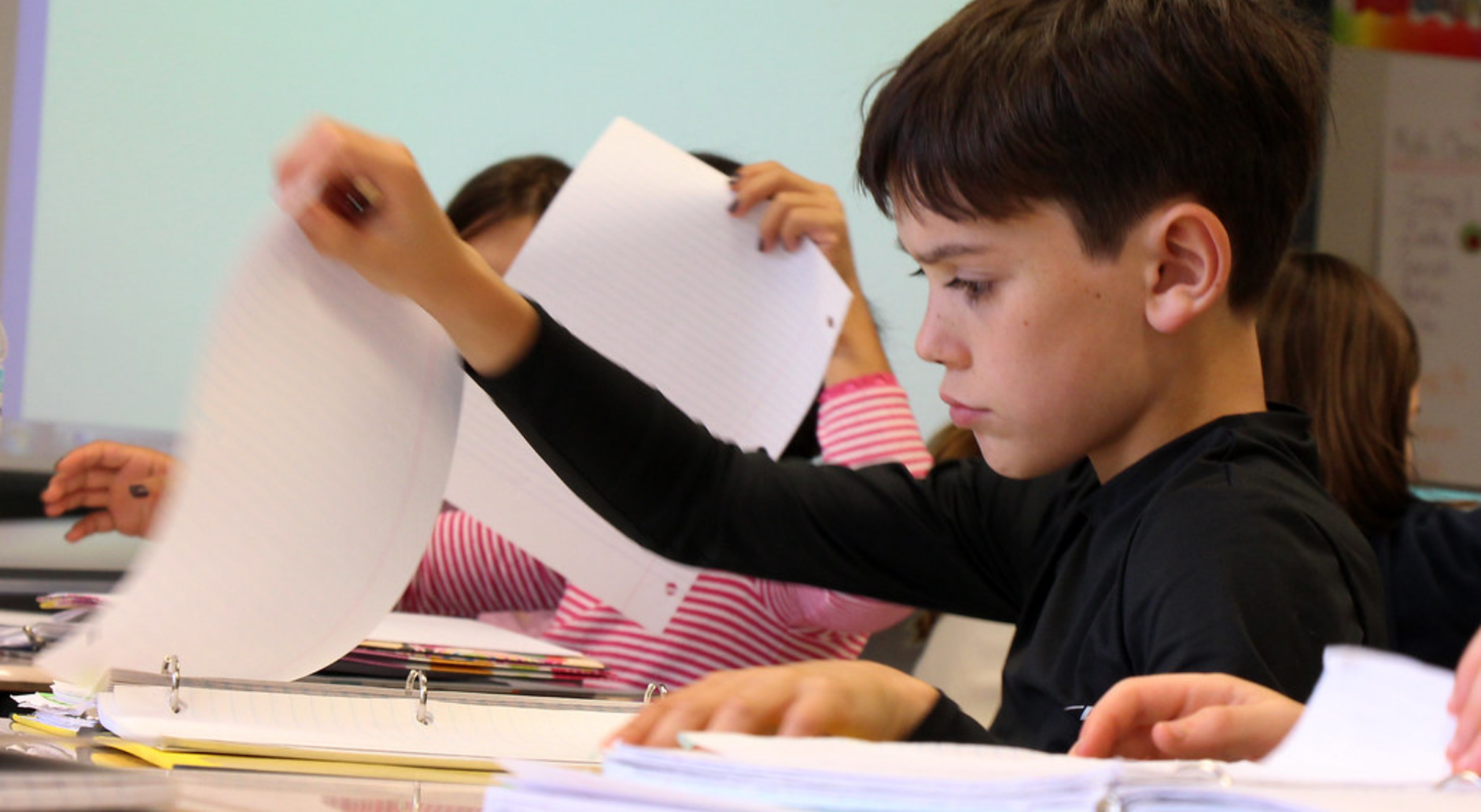 Child preparing to hand in homework.