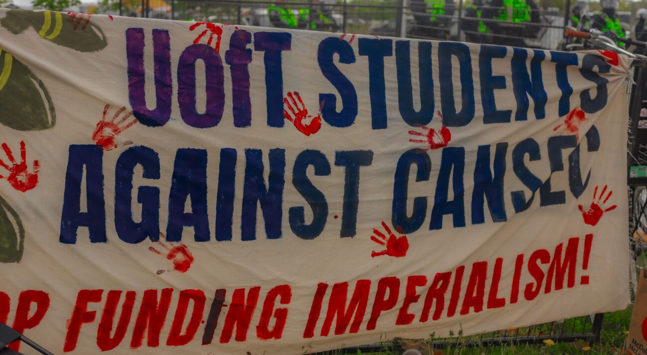 Banner that reads "UofT STUDENTS AGAINEST CANSEC." Photo: Bhoomi Dahiya/The Fulcrum.